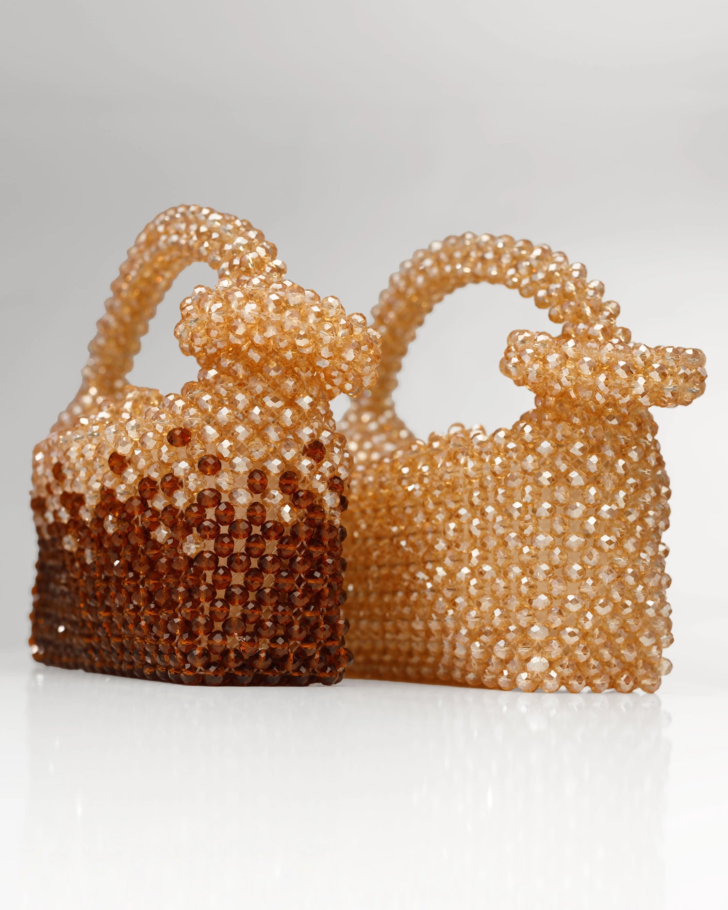 Unique, handmade gold and brown beaded handbag with halo detailing on a grey background, side view