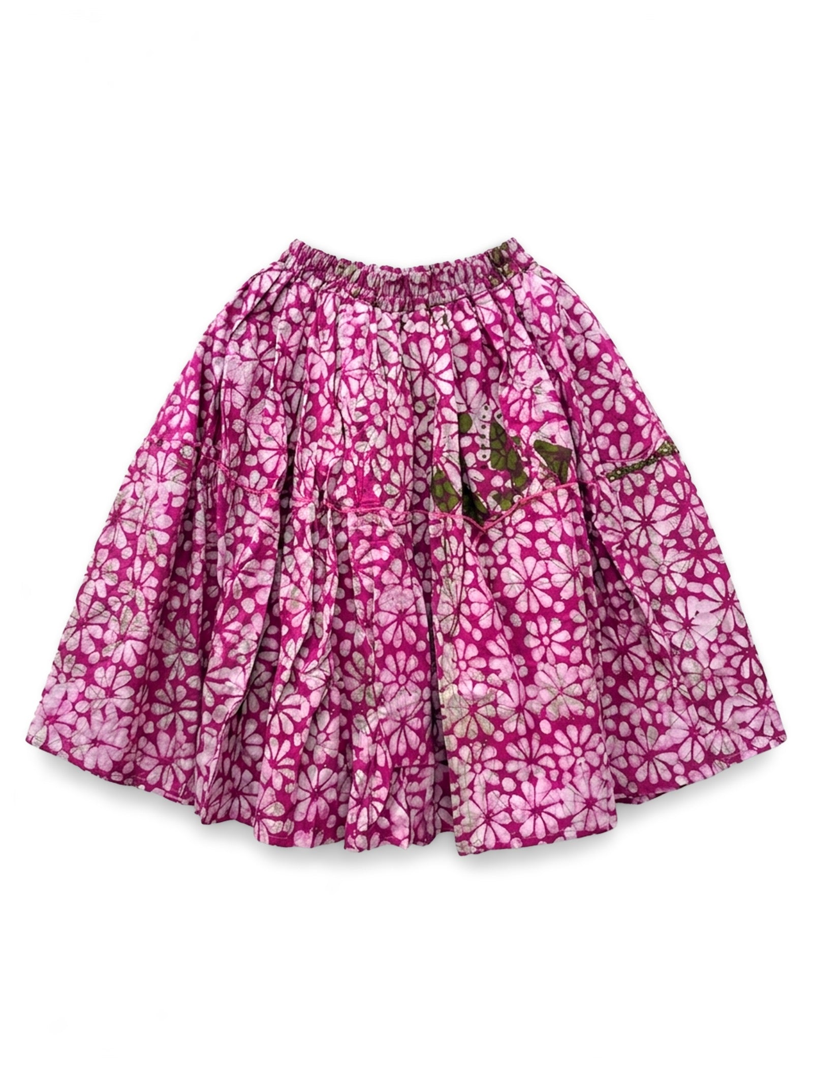 A pink and white floral print pleated skirt with a green embroidered butterfly detail on the front, displayed flat against a white background.