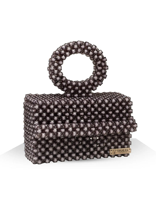 Unique, handmade black beaded handbag with halo detailing on a white background, front view