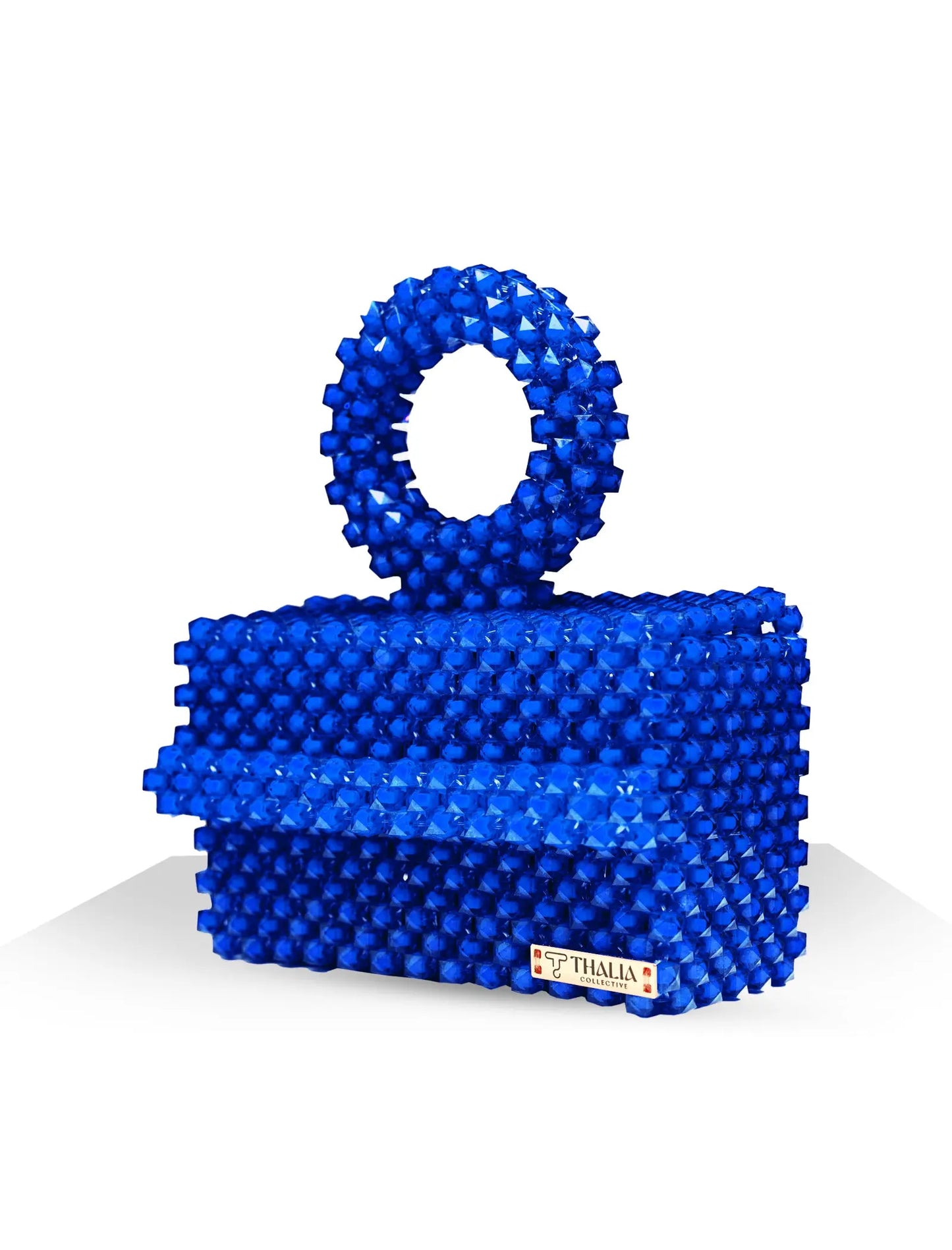 Unique, handmade blue beaded handbag with halo detailing on a white background, side view