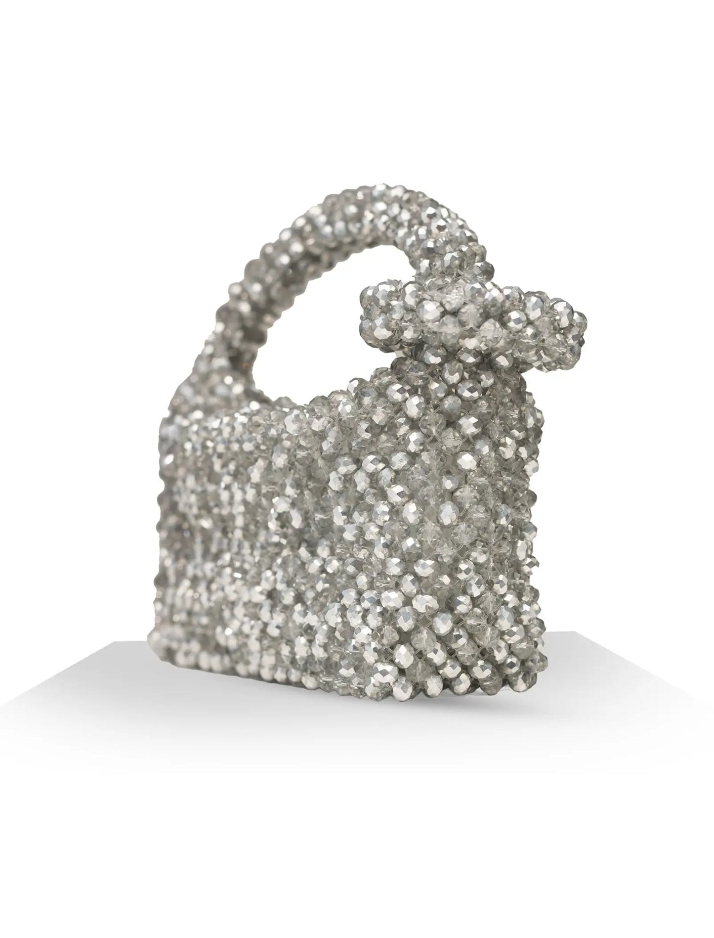 Unique, handmade silver shimmer beaded handbag with a bow on a white background, side view
