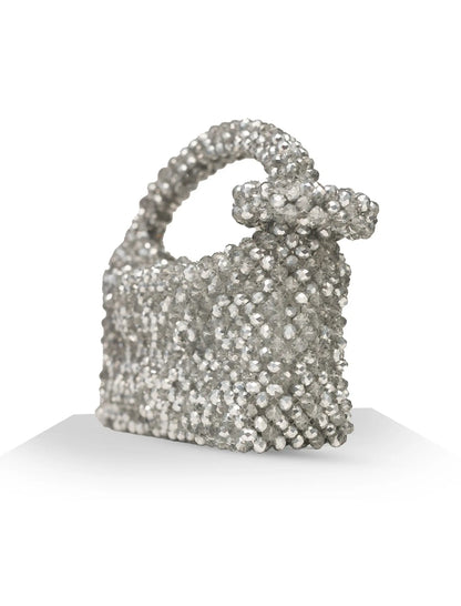 Unique, handmade silver shimmer beaded handbag with a bow on a white background, side view